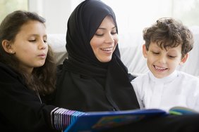 Photo of parent reading with children